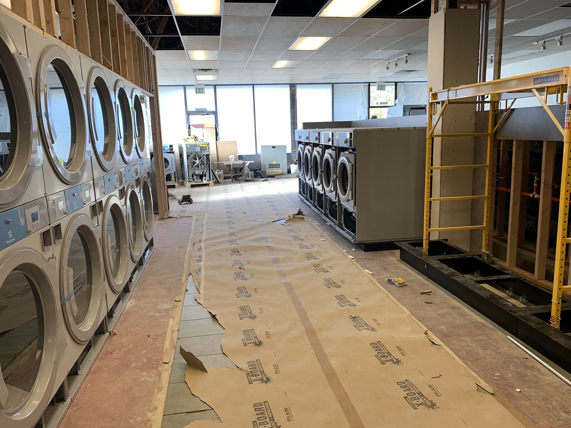 Laundromat build-out — Empty shells turned into working businesses.